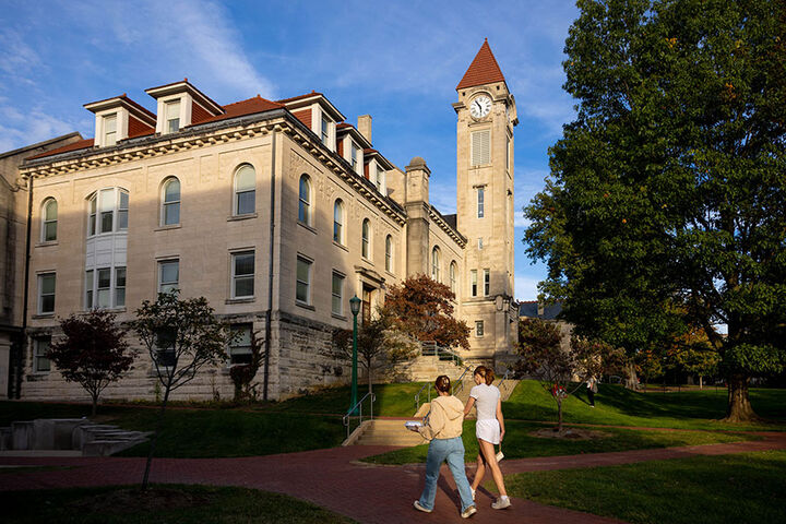Two students walk toward the Student Building on the IU Bloomington campus.